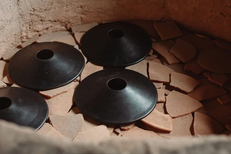 Artisan pottery kiln showcasing traditional craftsmanship with ceramic pieces and shards